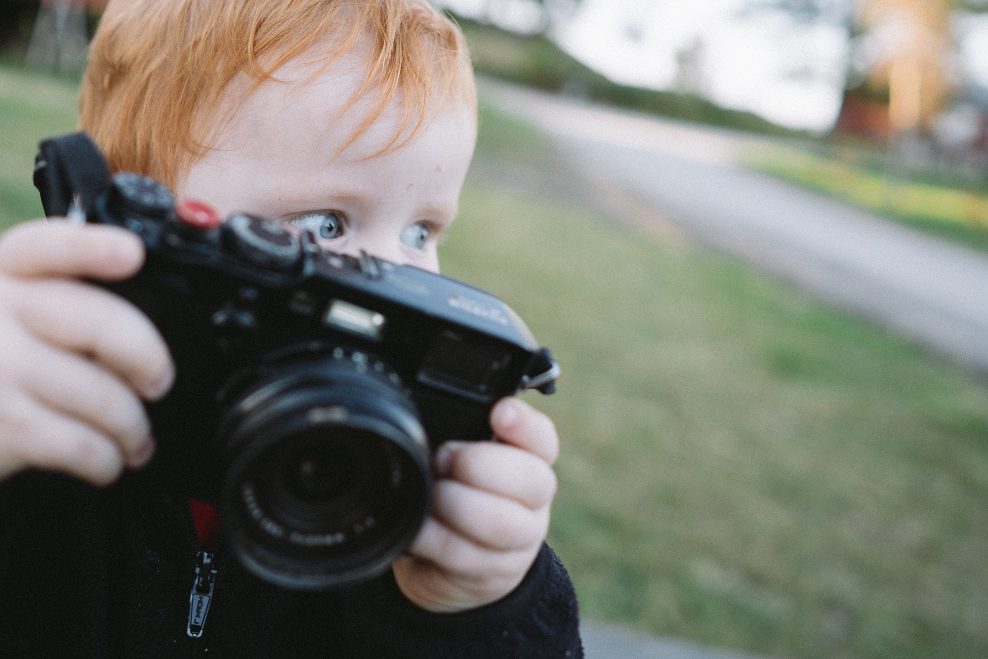 Gutt med kamera ser etter motiver å fotografere.
